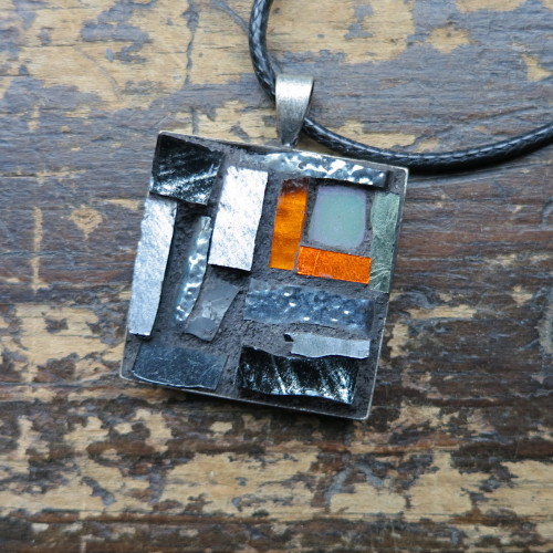 Gray Pendant with a Flash of Orange by Margaret Almon.