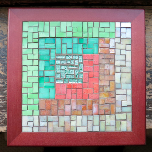 Asymmetric Log Cabin Trivet in Moss, Coral and Sand by Margaret Almon. Glass on wood, 8 inches.